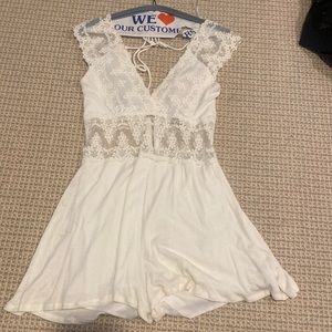 White lace size medium Hippie Love romper. Tie in the back and zipper in back.